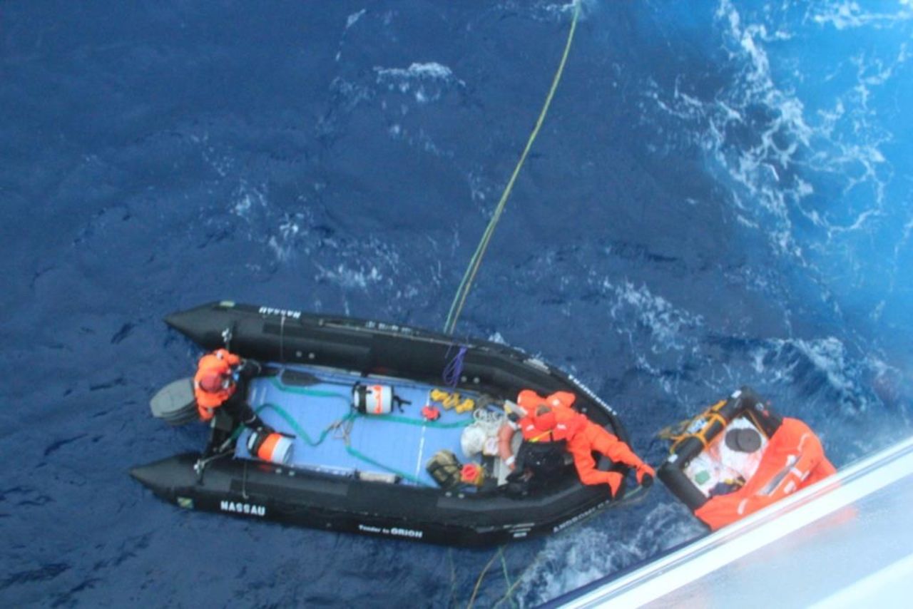 Delord is dragged from his life raft onto the rescue boat. He had been in the raft for almost 3 days.