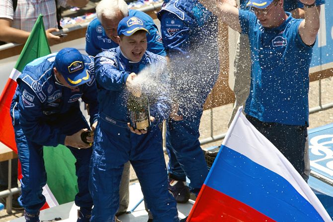 Kamaz team member Eduard Nikolaev sprays champagne to celebrate the team's first place in the 2013 Dakar Rally truck category on January 20.