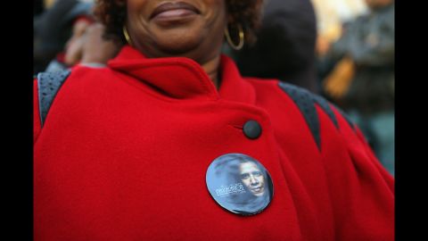 A woman with an Obama button waits near the Capitol on Monday.