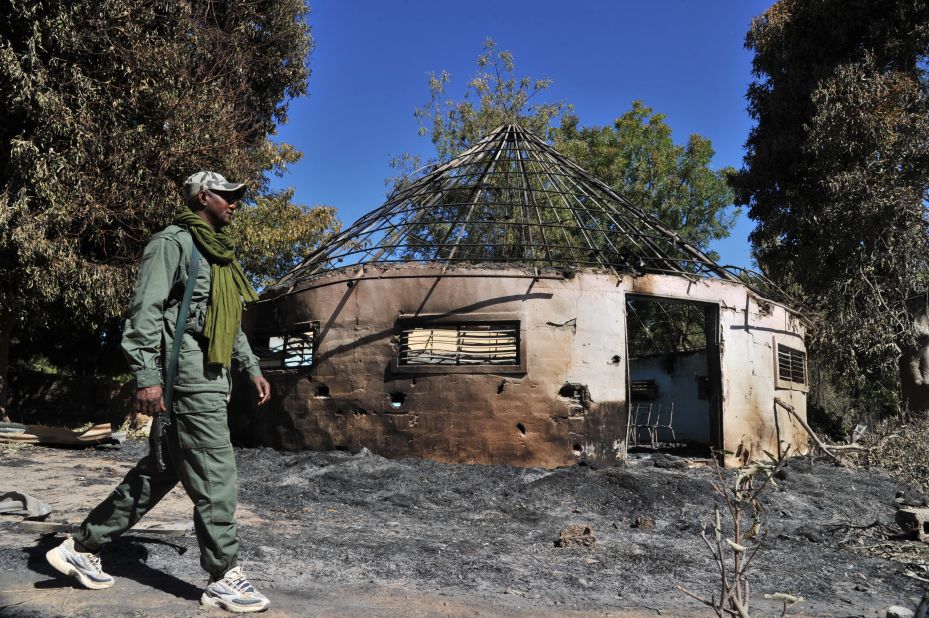 A Malian soldier walks past a army building that was taken by the jihadists before being destroyed during aerial bombing in Diabaly on January 21.