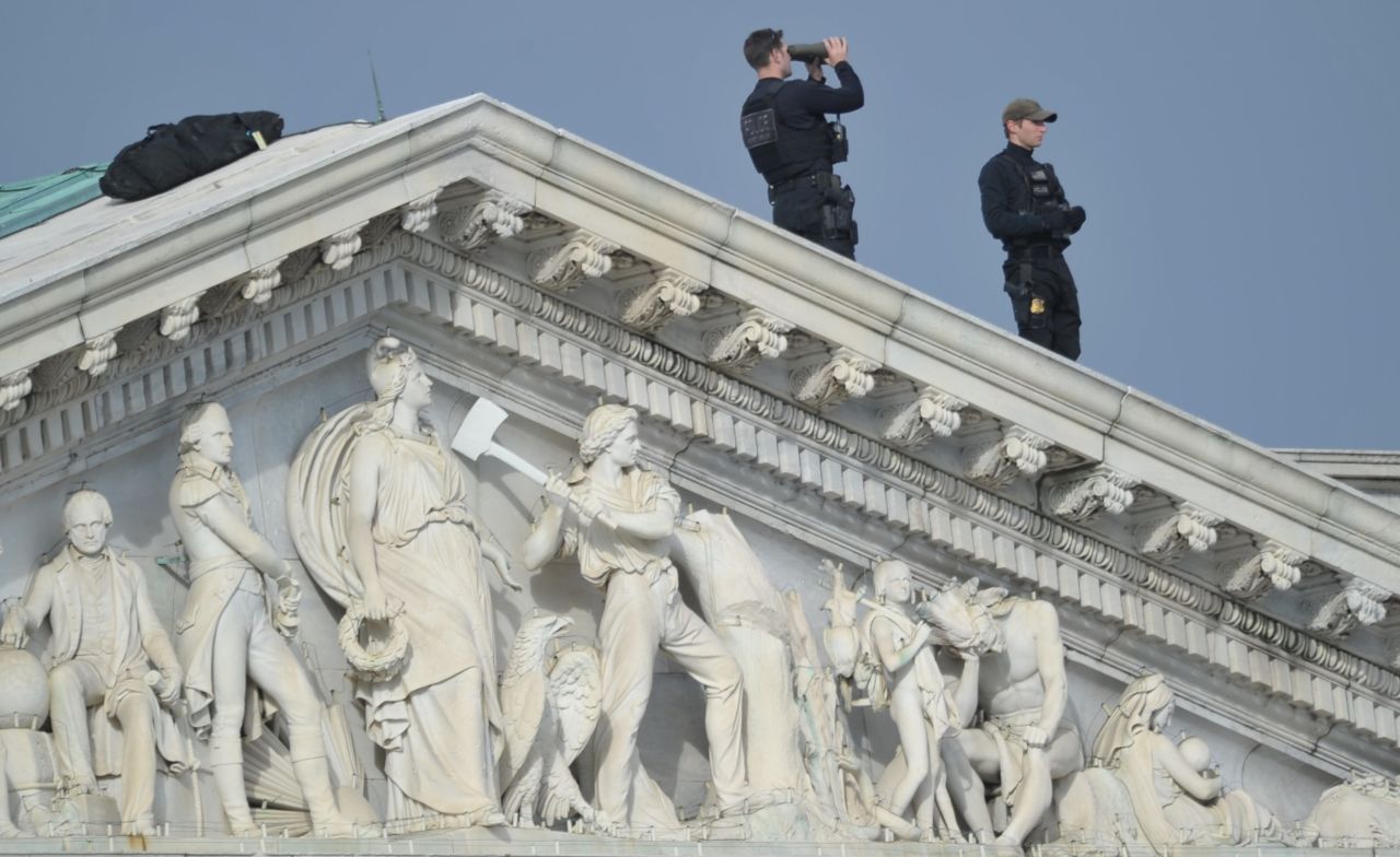 The U.S. Capitol Police stand guard Monday atop the Capitol.