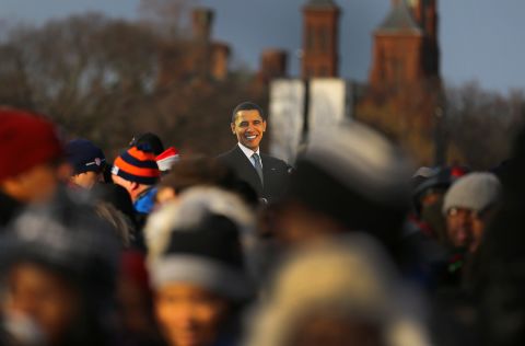 A presidential cutout rises above the crowd gathering Monday near the Capitol.