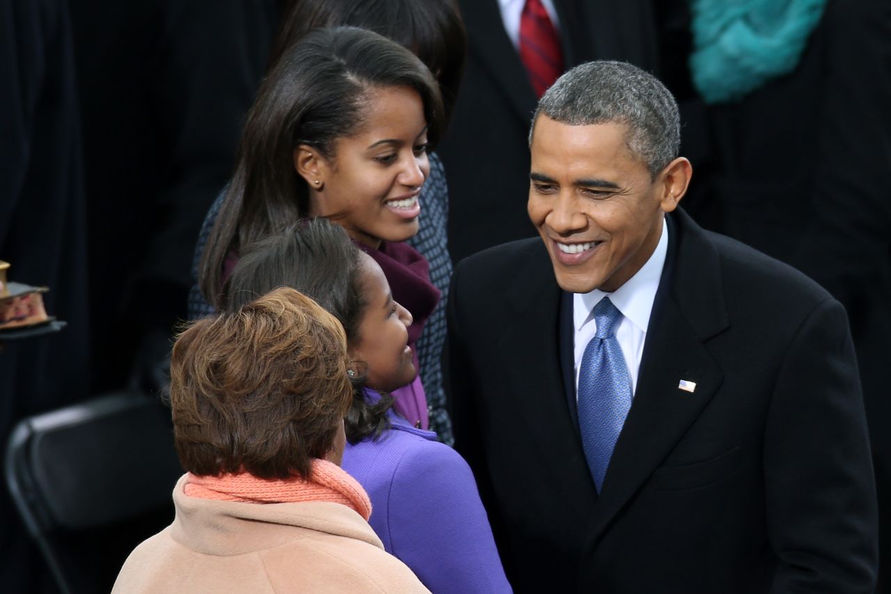 The president greets his daughters Sasha and Malia at the Capitol on Monday.