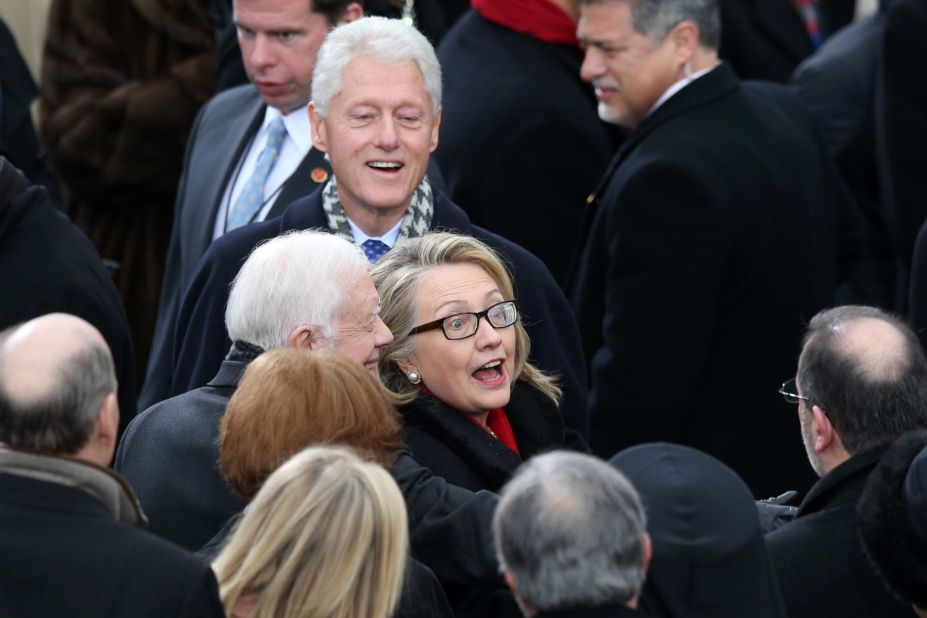 U.S. Secretary of State Hillary Clinton, former President Bill Clinton and former  President Jimmy Carter greet the crowd Monday.