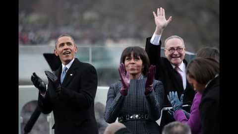 The president and first lady appear exuberant Monday as Democratic Sen. Charles Schumer of New York joins them at the inauguration.