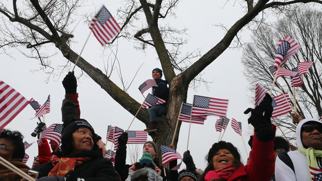 Attendees wave flags at the public ceremonial swearing-in ceremony for Obama on January 21.