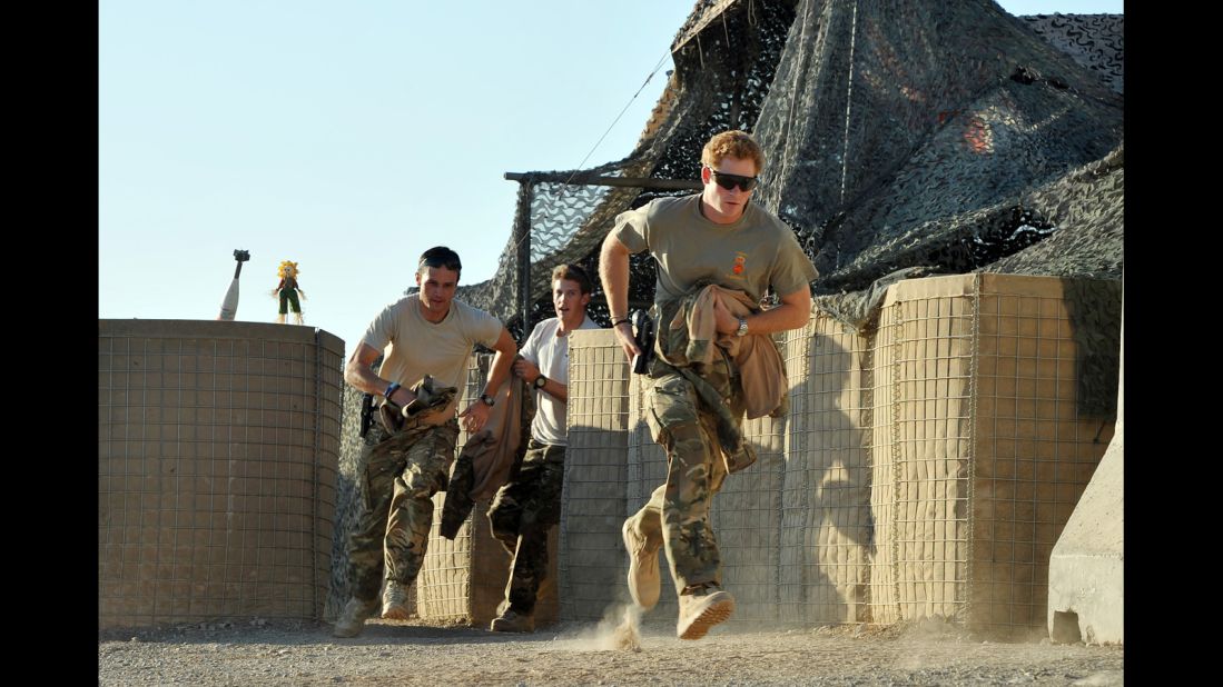 Harry runs from the VHR (very high readiness) tent to scramble his Apache helicopter with other pilots during a 12-hour shift at Camp Bastion on November 30, 2012.