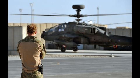 An Apache helicopter, returning from a mission, lands at Camp Bastion as Harry watches on November 3, 2012.