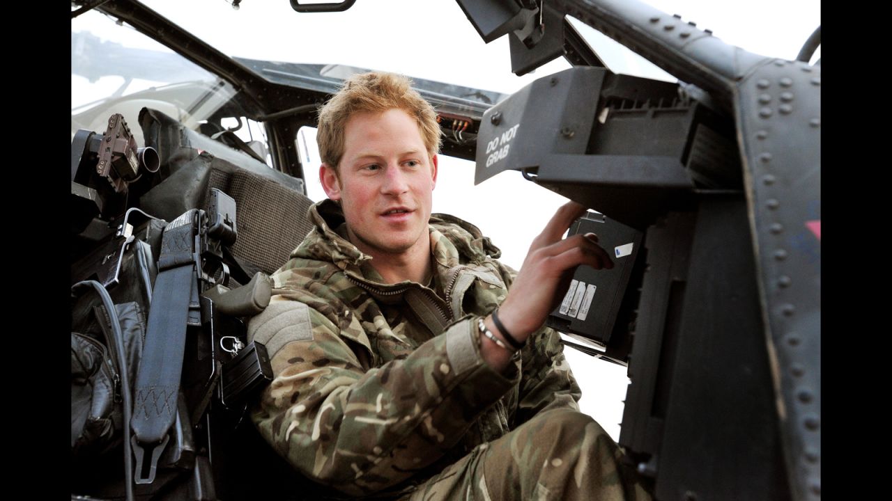 Harry performs a pre-flight check from inside the cockpit of an Apache helicopter in December 2012.