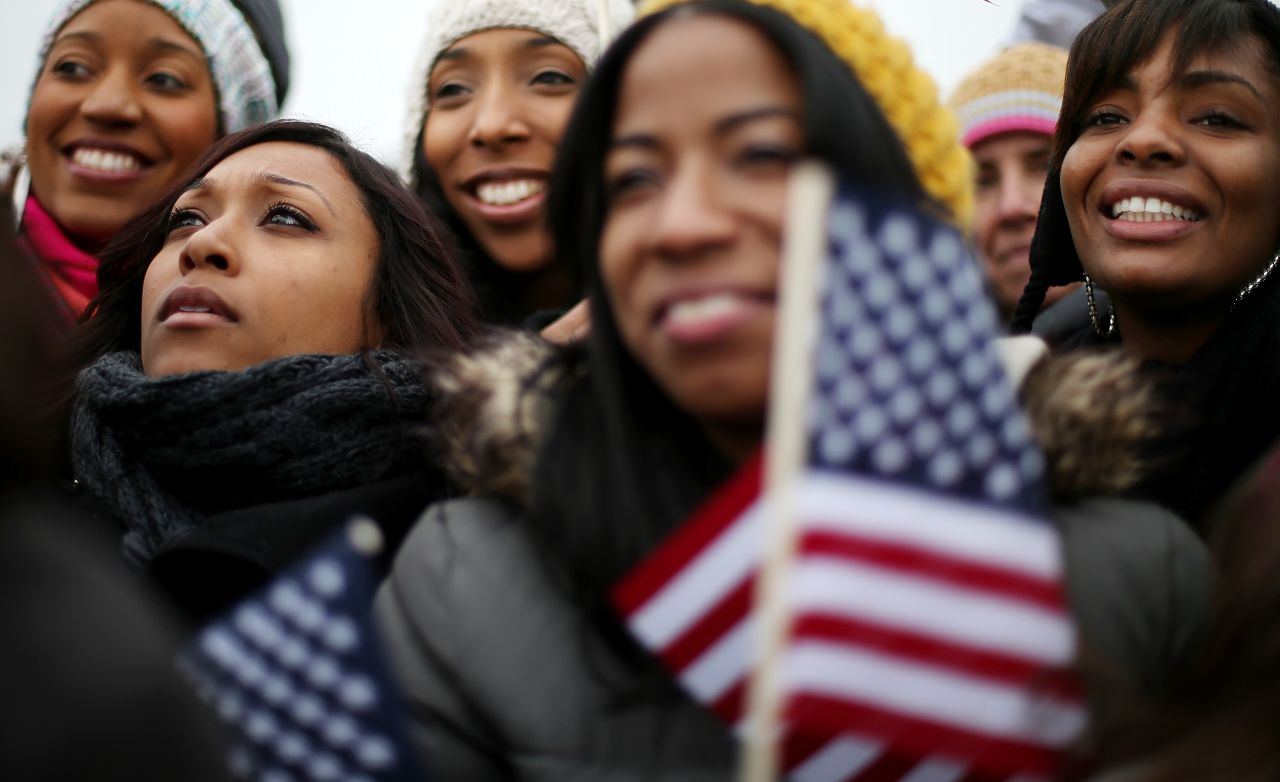 Left to right, Donica Perez, Janelle Stewart, Shani Perez, Kinda Romero and Danielle Houston watch the Inauguration on the Jumbotron near the U.S. Capitol building on the National Mall.