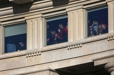 People watch as President Barack Obama and first lady Michelle Obama are driven past crowds during the Inauguration parade on Monday, in Washington. President Obama was sworn in for a second term office at the U.S. Capitol building. 