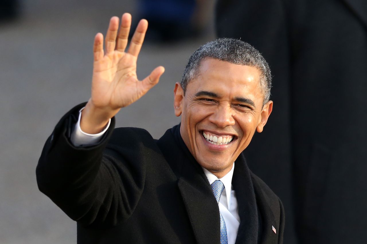 President Obama waves as the presidential inaugural parade winds through the nation's capital on Monday.