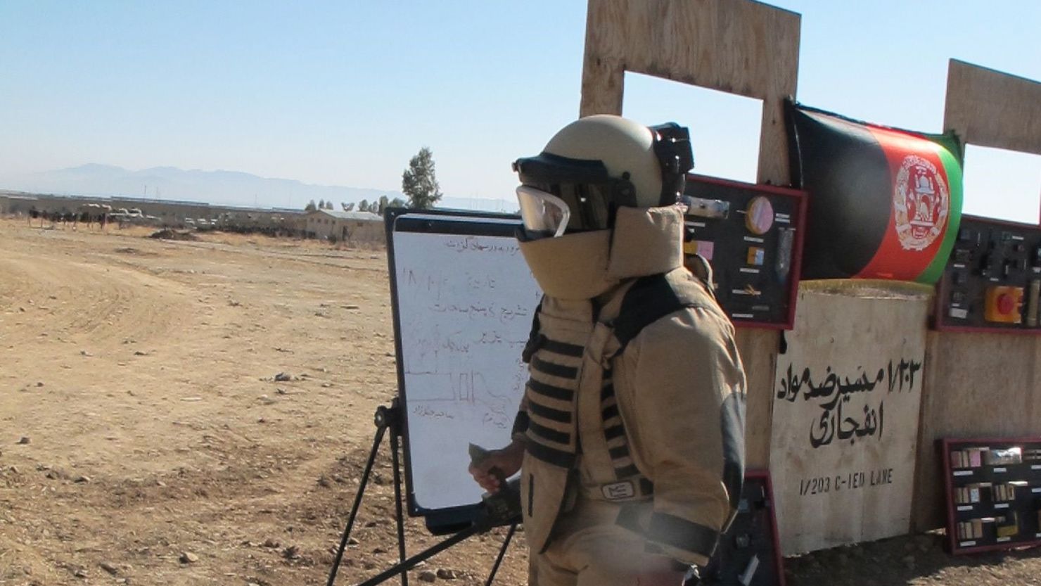 A bomb-suited soldier with the Afghan National Army trains to defuse explosives in Khost Province, eastern Afghanistan.