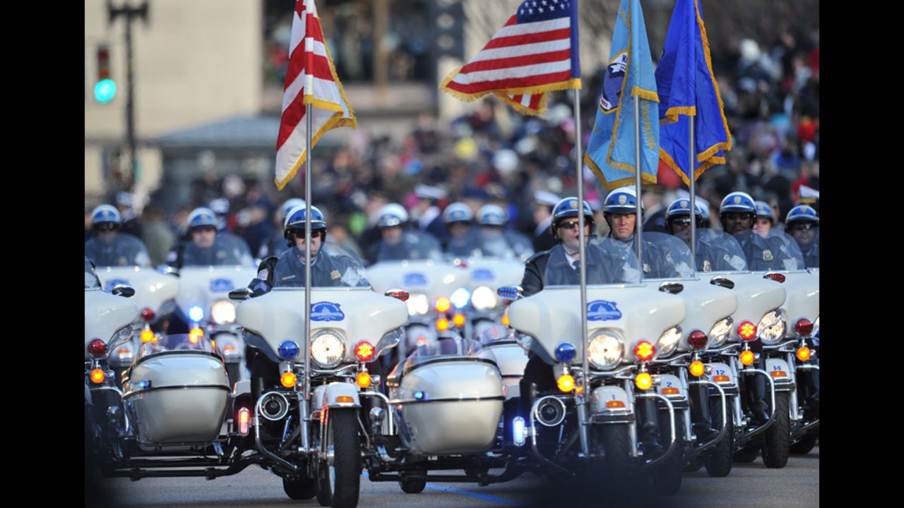 Police take the lead in the inaugural parade January 21 as the first couple walk down a part of Pennsylvania Avenue.