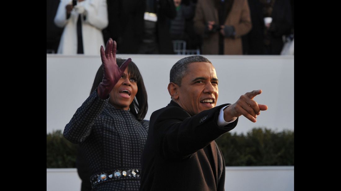 The president and first lady greet crowds as they move along Pennsylvania Avenue on January 21.