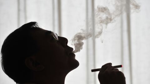 The inventor of the electronic cigarette, Hon Lik smokes his invention in Beiijng on May 25, 2009.