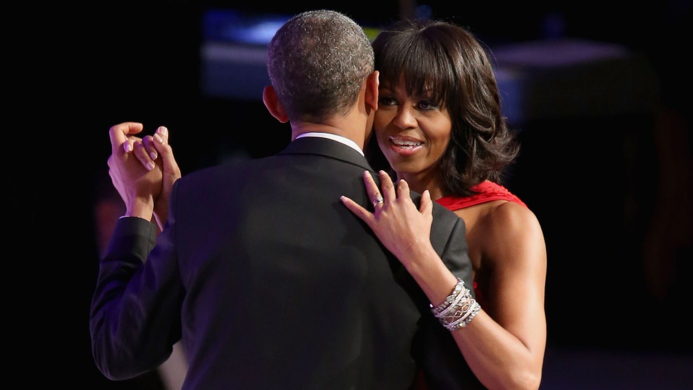 Michelle Obama dances cheek to cheek with President Obama.