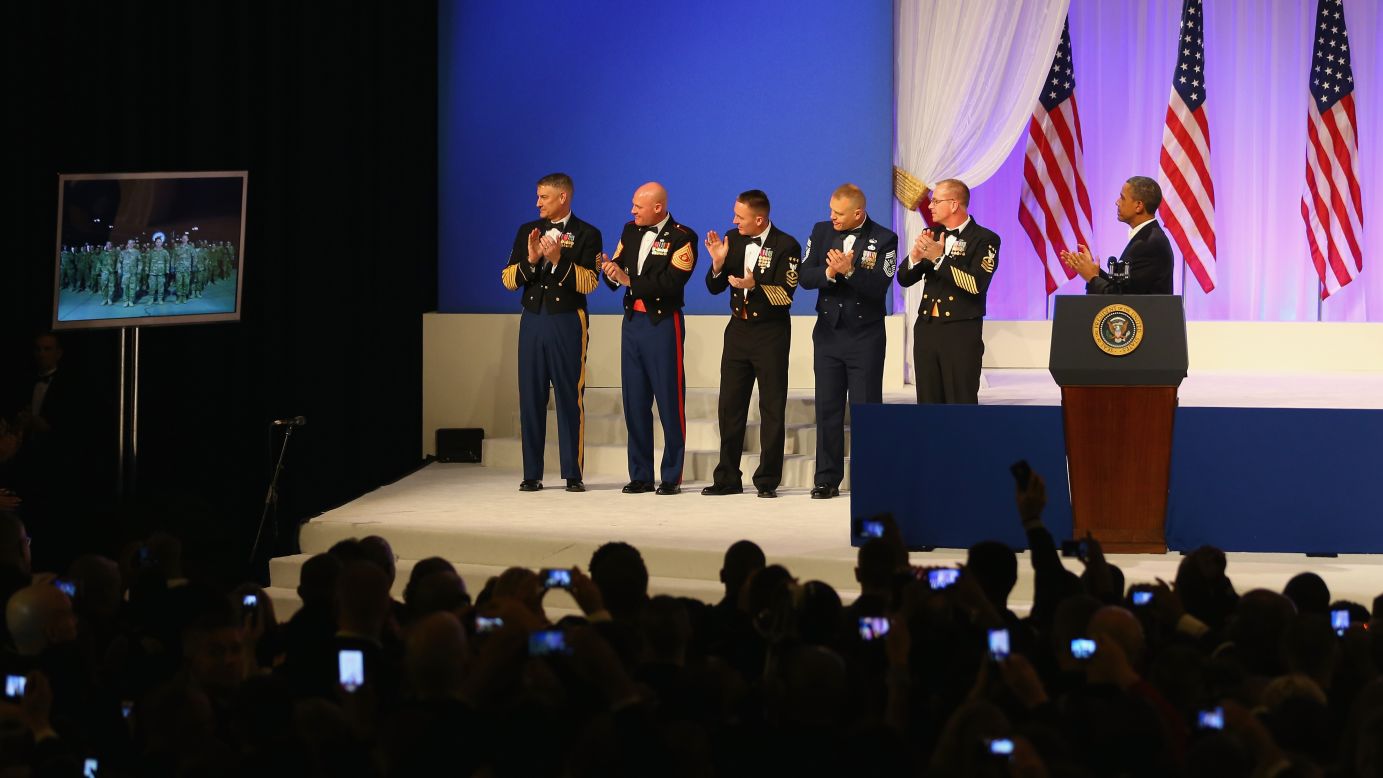President Obama applauds while speaking with American soldiers in Kandahar, Afghanistan, during Monday's first inaugural ball.