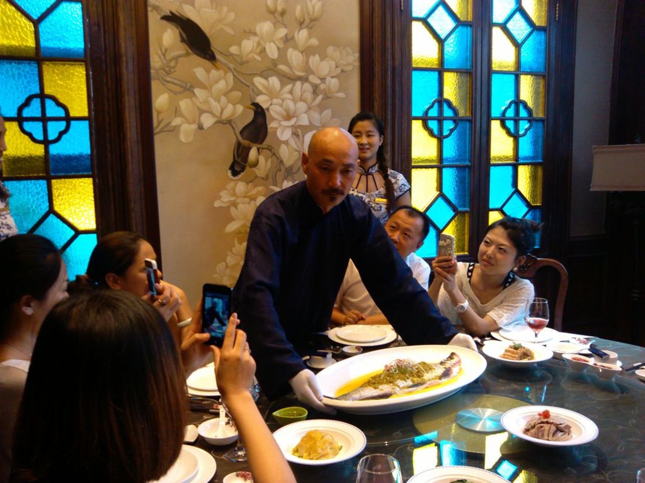 Dressed as Chiang Kai-shek, Xu Jinshui showcases food popular during the Republican period at a restaurant in Nanjing.