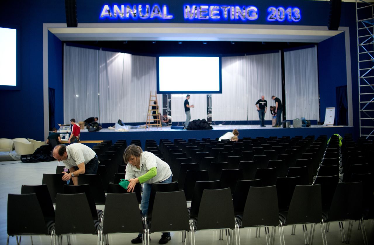Employees clean the chairs in the main hall at the congress center on January 21, 2013 at the Swiss resort of Davos.