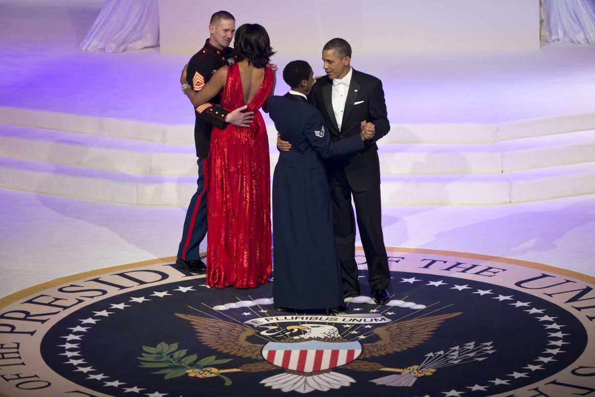 President Obama and the first lady dance with service members.