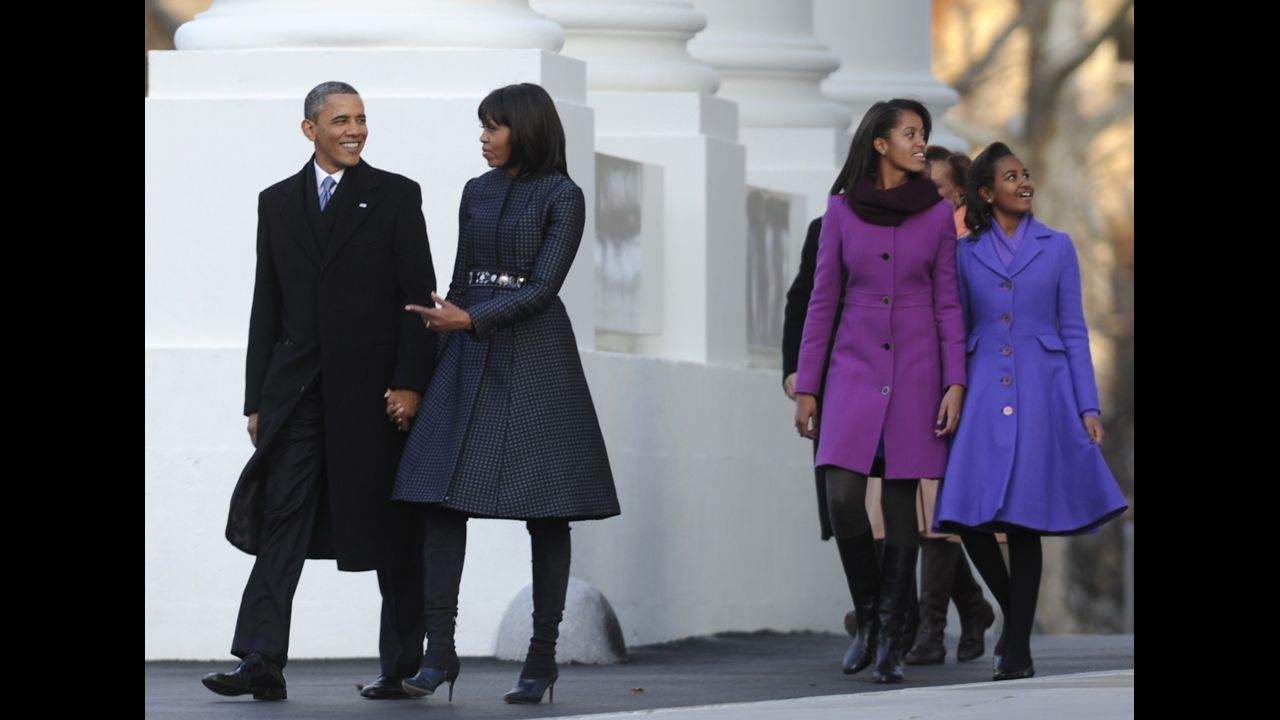 Sasha and Malia walk with their parents to the reviewing stand on Pennsylvania Avenue to watch the Parade during the 57th Presidential Inauguration.