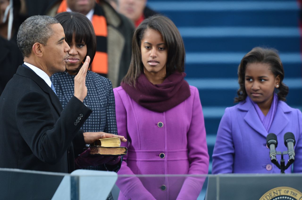 President Obama takes the oath of office while his wife, first lady Michelle Obama, and daughters Malia and Sasha, watch during the 57th Presidential Inauguration ceremonial swearing-in at the U.S. Capitol.