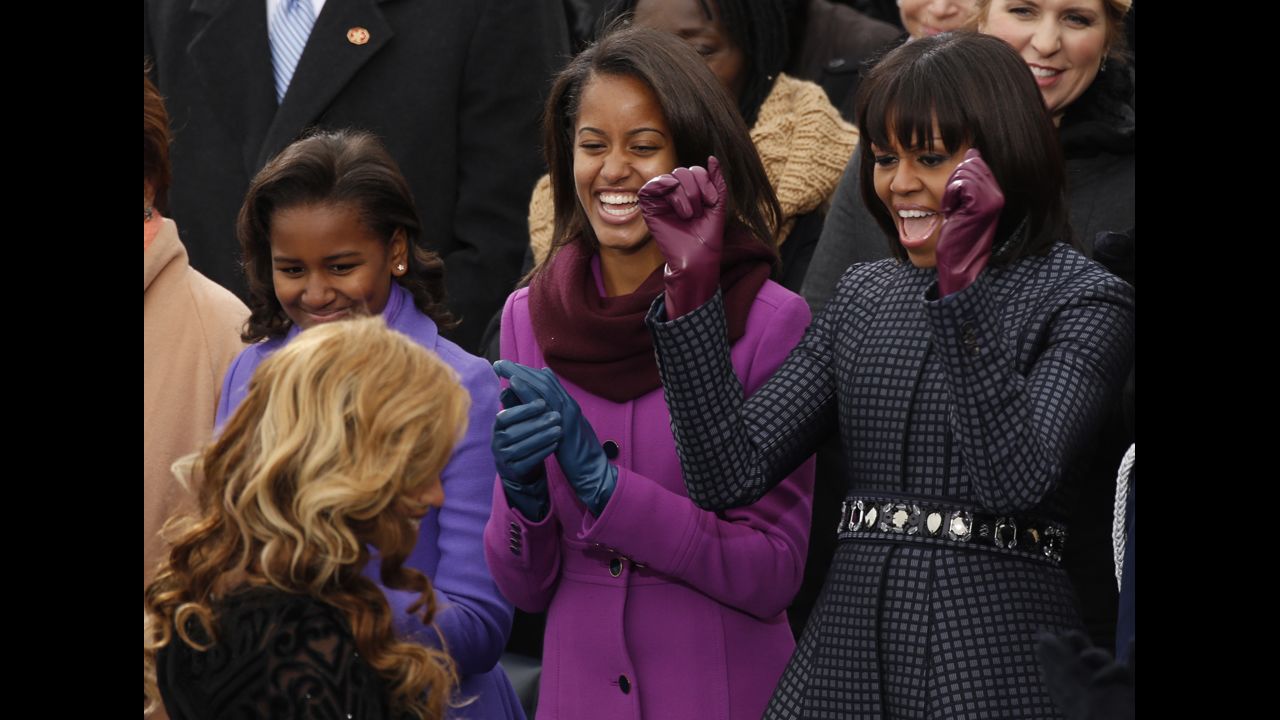 From right, first lady Michelle Obama and her daughters Malia and Sasha cheer as performer Beyonce returns to her seat after singing the Star Spangled Banner after the swearing-in of President Obama.