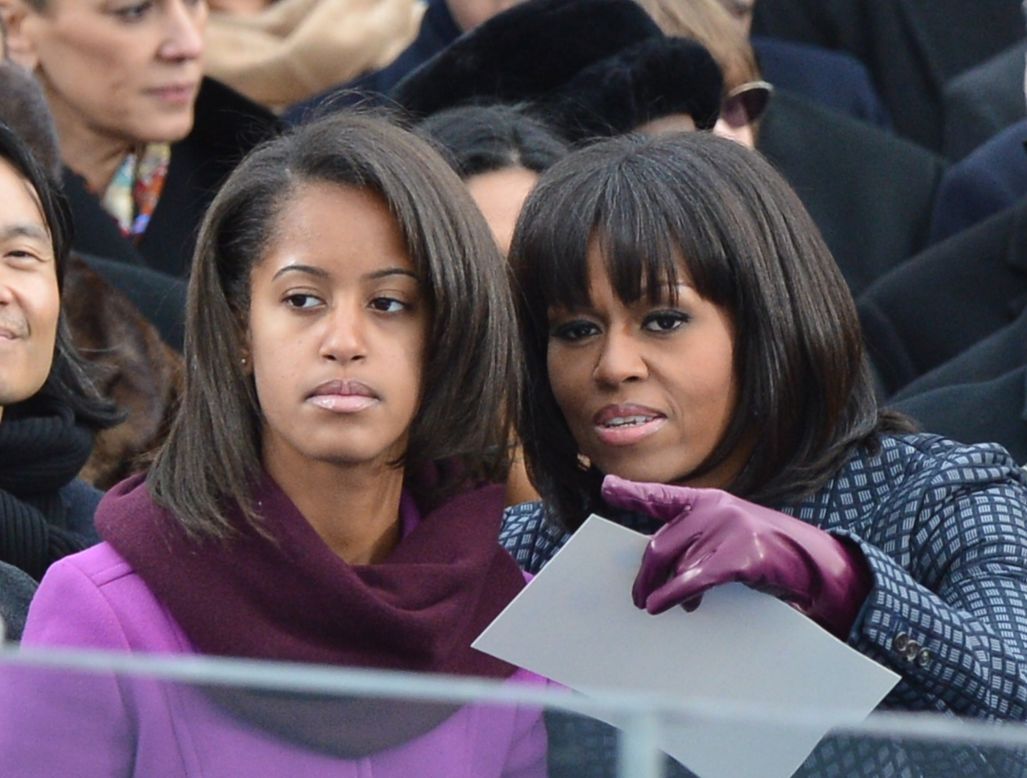 First lady Michelle Obama points something out to her daughter Malia.