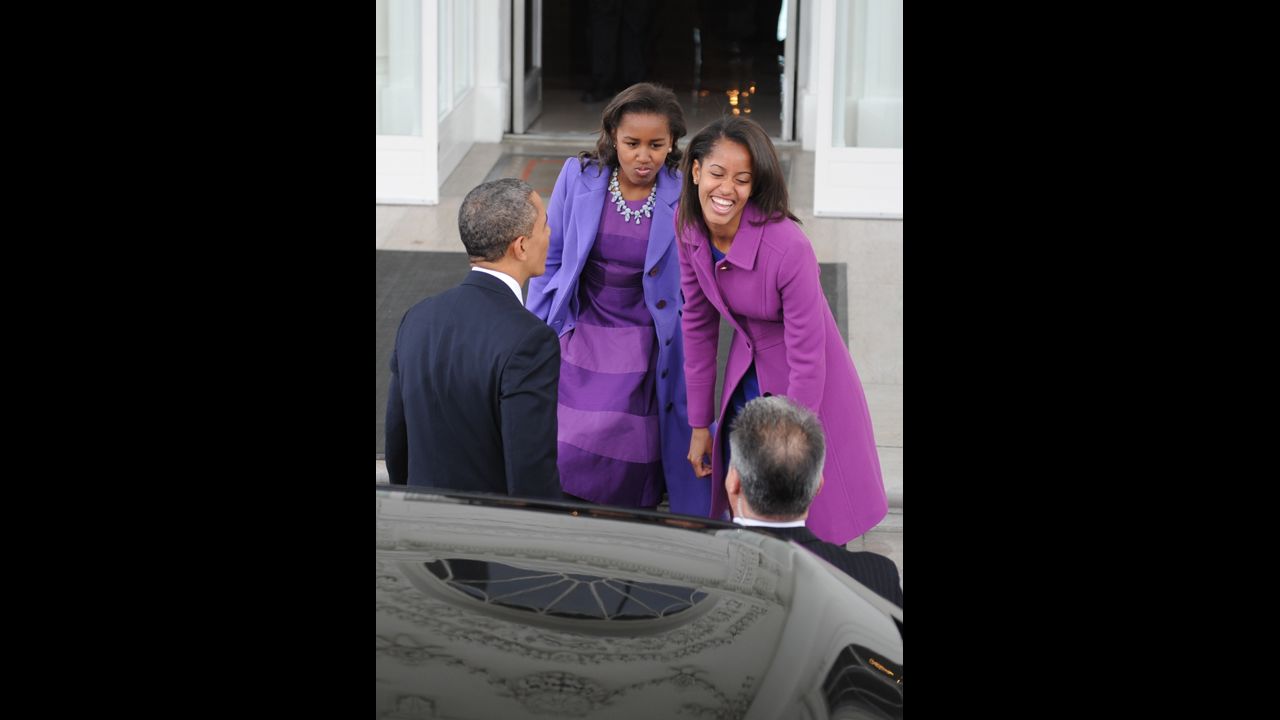 President Obama and his daughters return to the White House from St. John's Episcopal Church in Washington, after prayer services.