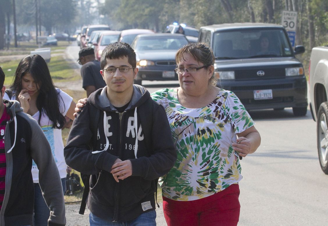 A mother joins her son as he evacuates the  campus on foot. 