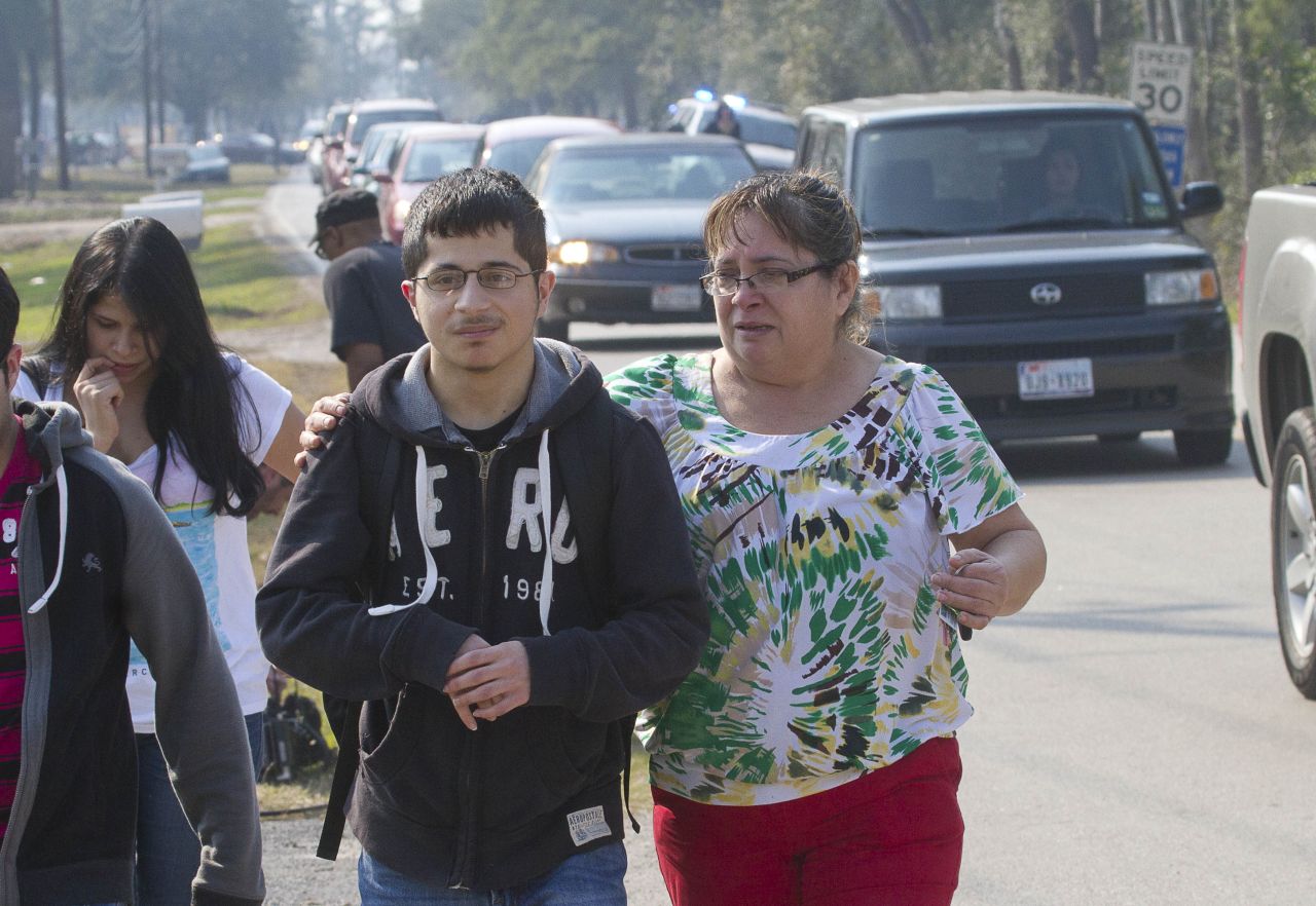 A mother joins her son as he evacuates the  campus on foot. 