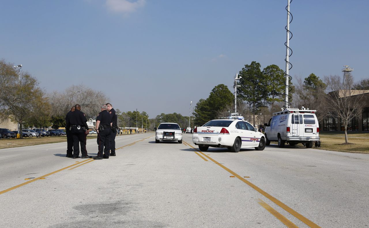 Law enforcement secures the area near Lone Star College. Authorities were searching for a suspect in a wooded area next to the campus, a law enforcement source said.