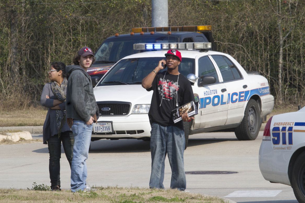 Students talk on cell phones and wait after evacuating the campus.