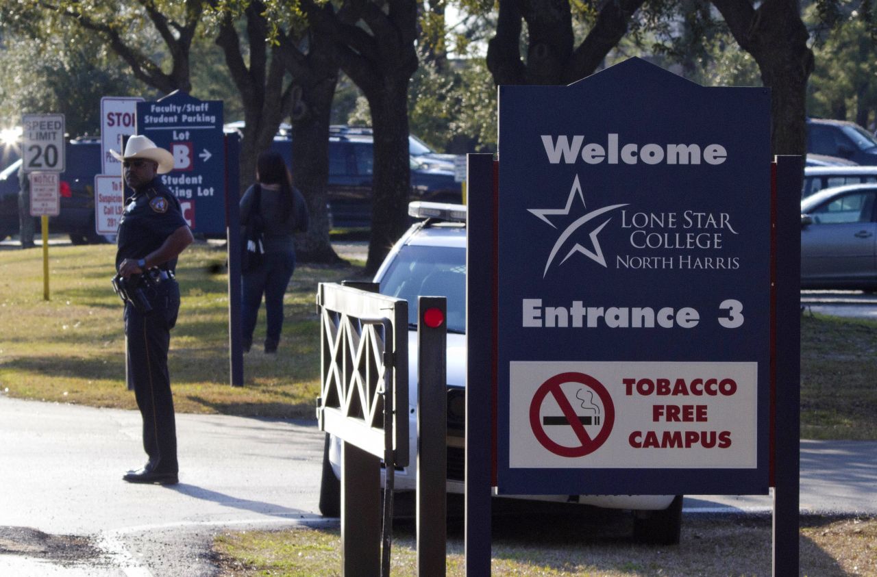 A sheriff's deputy stands guard at the entrance to Lone Star College's North Harris campus on January 22. The campus was put on lockdown following reports of the shooting. 