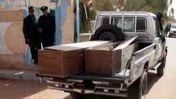 Algerian security personnel monitor as empty coffins are transported to collect victims that were killed during the hostage crisis at a desert gas plant in Algeria's deep south on January 21, 2012 in In Amenas.