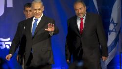 Israeli Prime Minister Benjamin Netanyahu (L) and ultra-nationalist Avigdor Lieberman (R) of the Likud-Beitenu coalition party greet supporters as they arrive on stage on elections night on January 22, 2013 at the party's headquarters in Tel Aviv. Netanyahu said it was necessary to form the 'broadest possible government' after his Likud-Beitenu list won a narrow election victory, with the centrist Yesh Atid in second place. AFP PHOTO / JACK GUEZ (Photo credit should read JACK GUEZ/AFP/Getty Images)