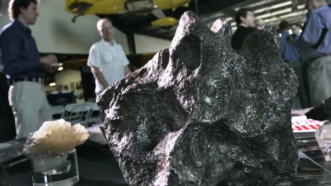 Meteorites sit on a display table Tuesday at the Deep Space Industries announcement of plans for the world's first fleet of commercial asteroid-prospecting spacecraft at the Museum of Flying in Santa Monica, California.