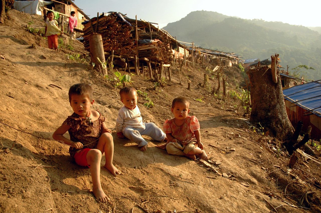 Kachin children play outside wooden shacks at the N-Hkawng Pa Internally Displaced People's (IDP) camp outside Mai Ja Yang, May 2012.