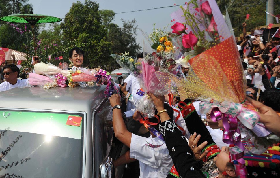 Kachin people greet Myanmar opposition leader Aung San Suu Kyi at Myitkyina airport on February 23, 2012. Suu Kyi has urged an immediate end to hostilities in Kachin State.