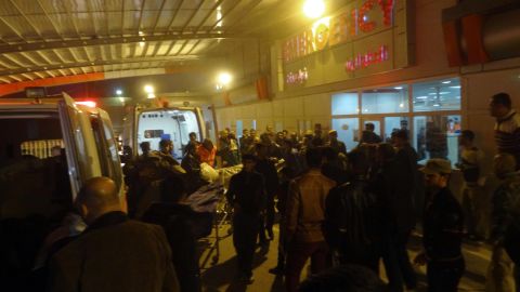 People gather around the entrance of a hospital in Kirkuk, north of Baghdad, on Wednesday, after suicide bombing attack.