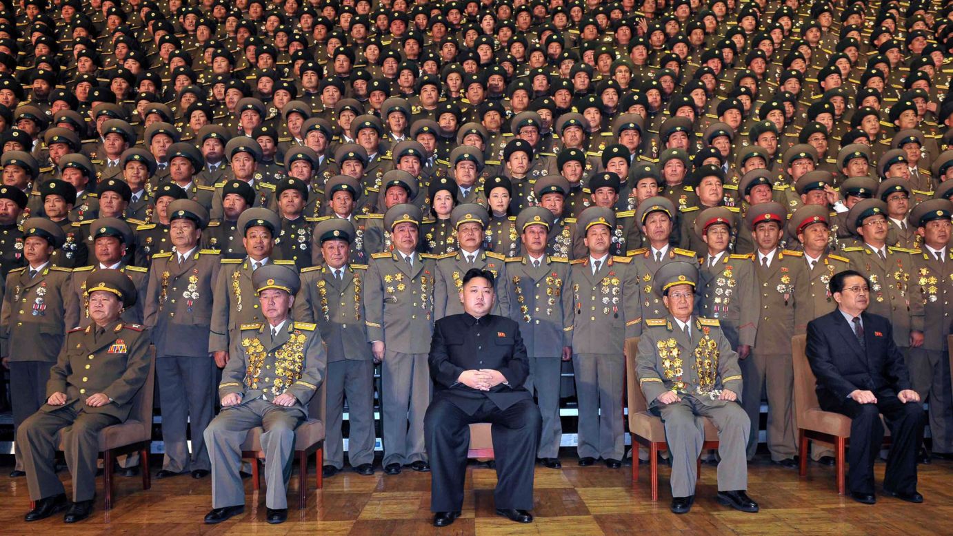 Kim, center, poses in this undated picture released by North Korea's official news agency in November 2012.