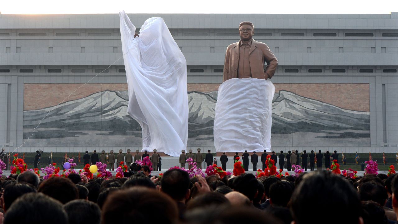 A crowd watches as statues of North Korean founder Kim Il Sung and his son Kim Jong Il are unveiled during a ceremony in Pyongyang in April 2012.