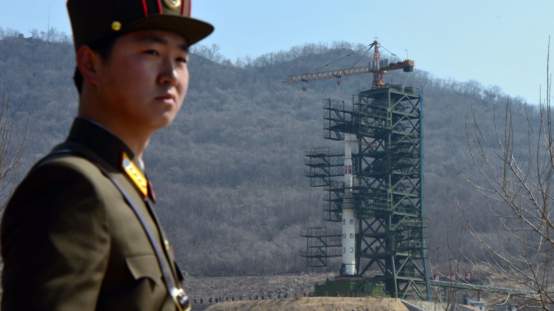 A North Korean soldier stands guard in front of an UNHA III rocket at the Tangachai-ri Space Center in April 2012.