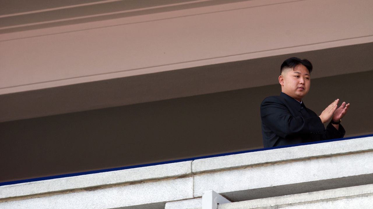 Kim Jong Un applauds as he watches a military parade in Pyongyang in April 2012.