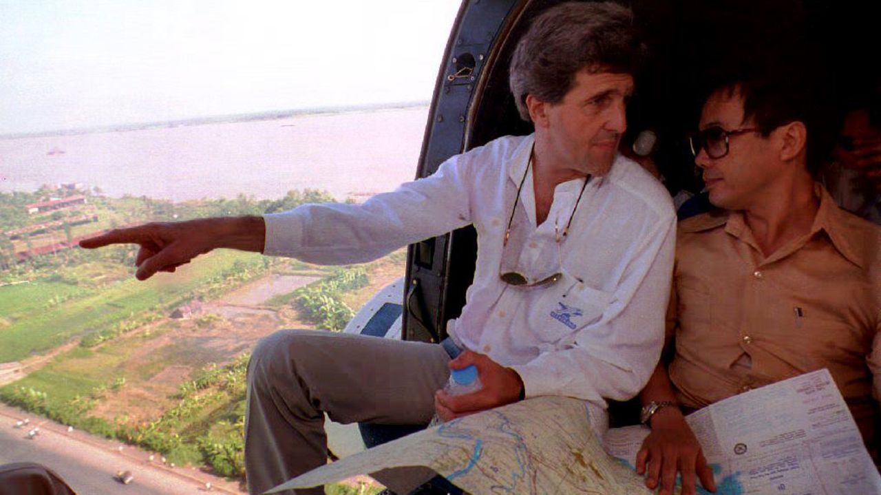 Kerry looks over a map with Nguen Xuan Phong of the Vietnamese Foreign Ministry while flying over the Mekong River Delta on November 20, 1992.