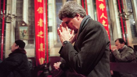 Kerry prays during an early Mass on January 11, 1994, at the Bei Hai Cathedral in Beijing. He paid his respects to Tip O'Neill, former speaker of the House of Representatives, whose funeral would be held later in the day in Washington.