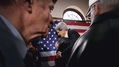 Kerry and a veteran embrace at a town hall meeting at the Black Hawk County Soldiers Memorial Hall on January 13, 2004, in Waterloo, Iowa.