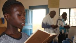 In a synagogue in Nigeria, 14-year-old Kadmiel Izungu Abhor reads from a prayer book during Shabbat service
