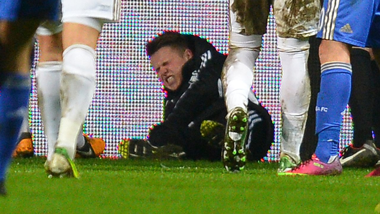 Swansea ball boy Charlie Morgan grimaces after the incident which led to Eden Hazard's sending off. 